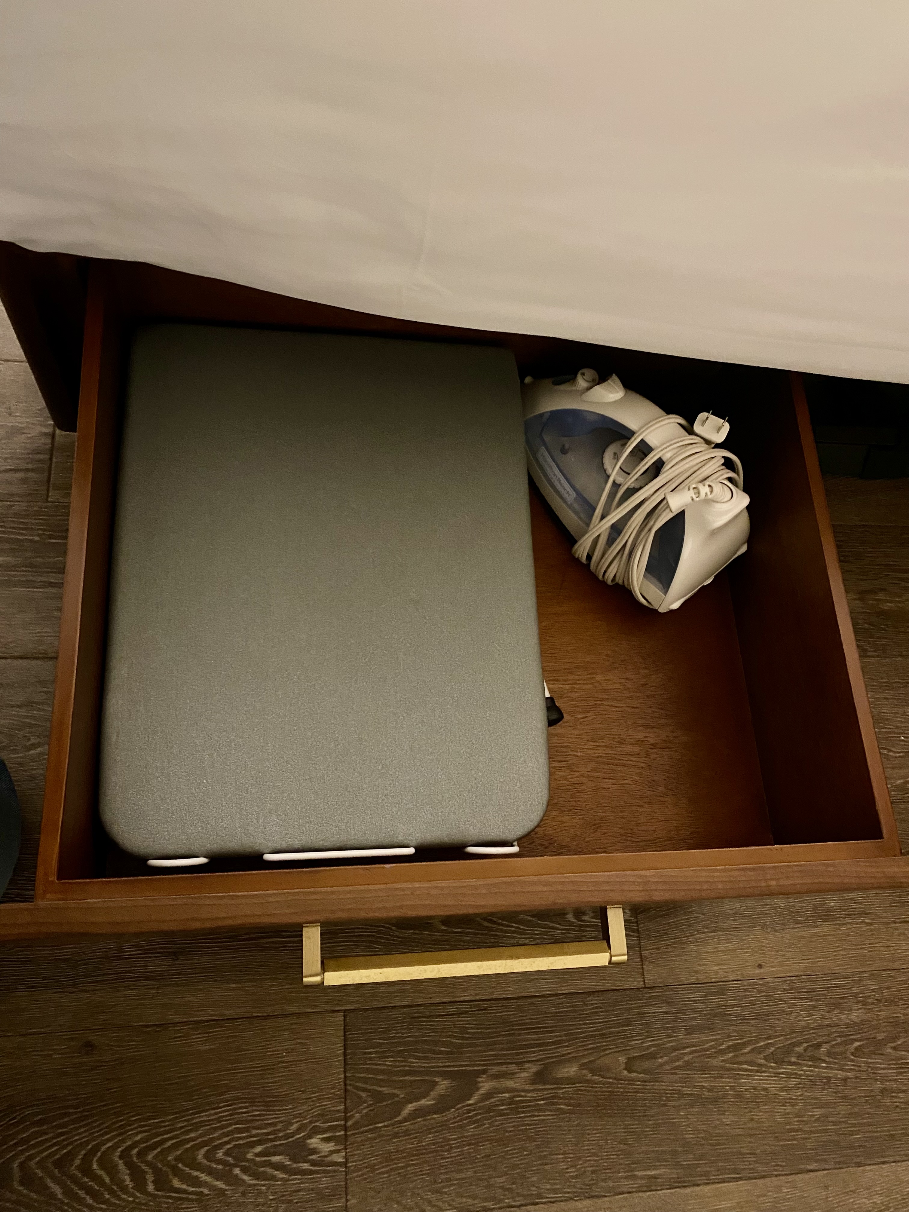 a laptop and shoe in a drawer