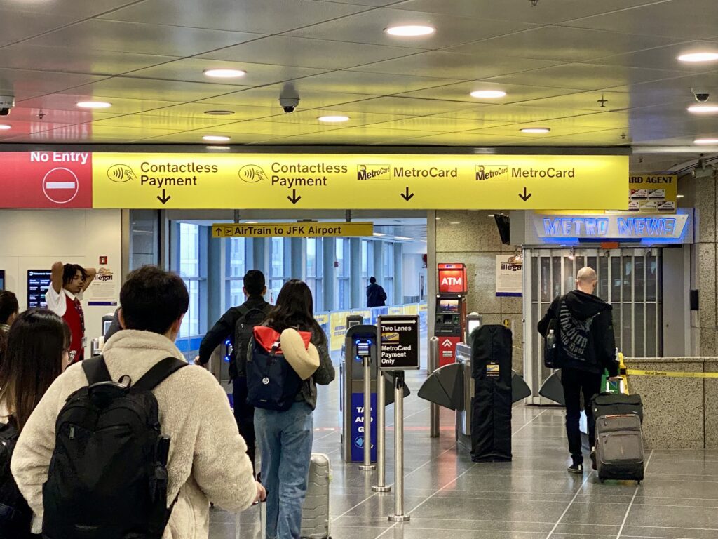 people in a terminal with a group of people walking