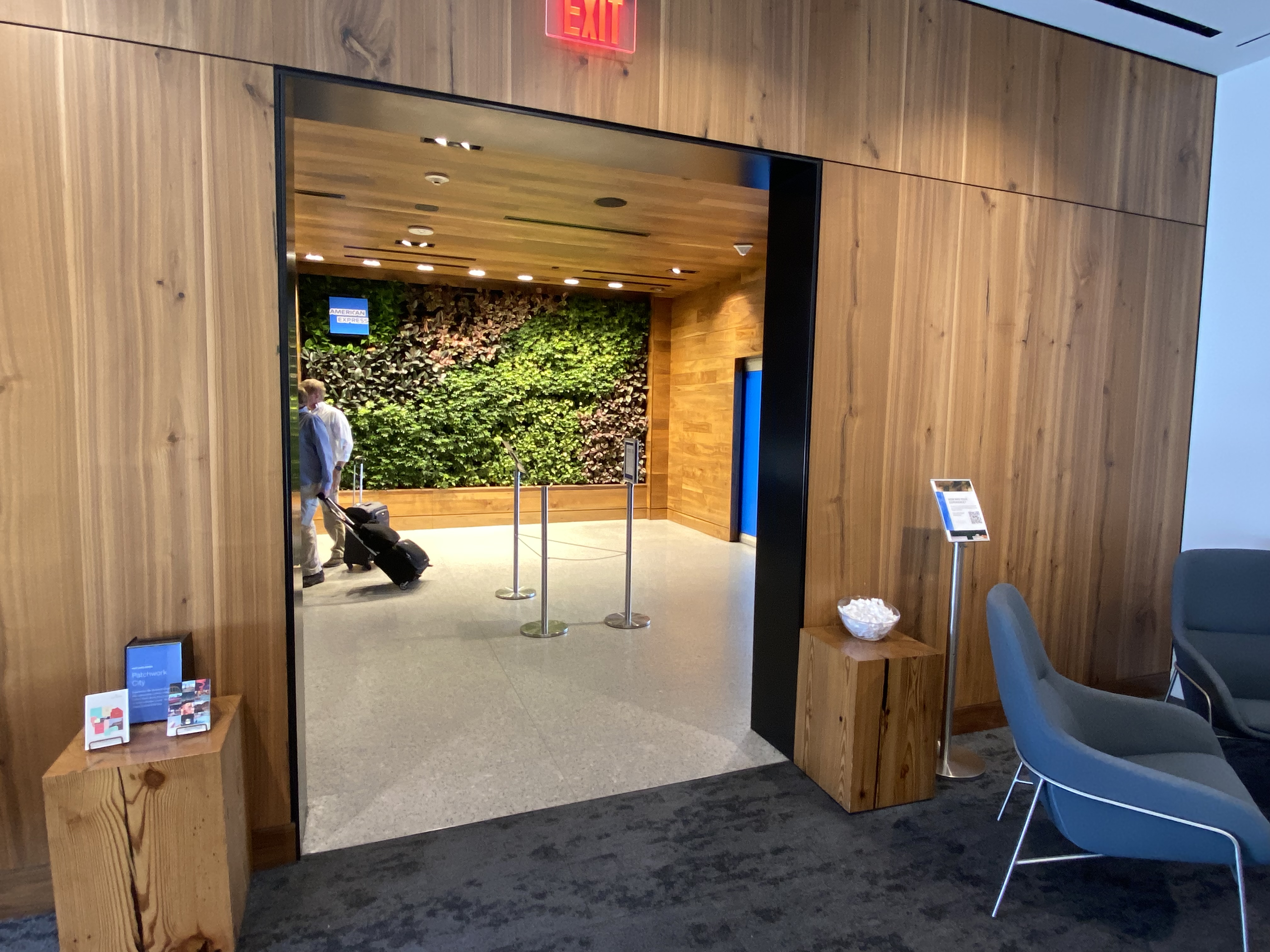 a man with luggage in a room with a green wall