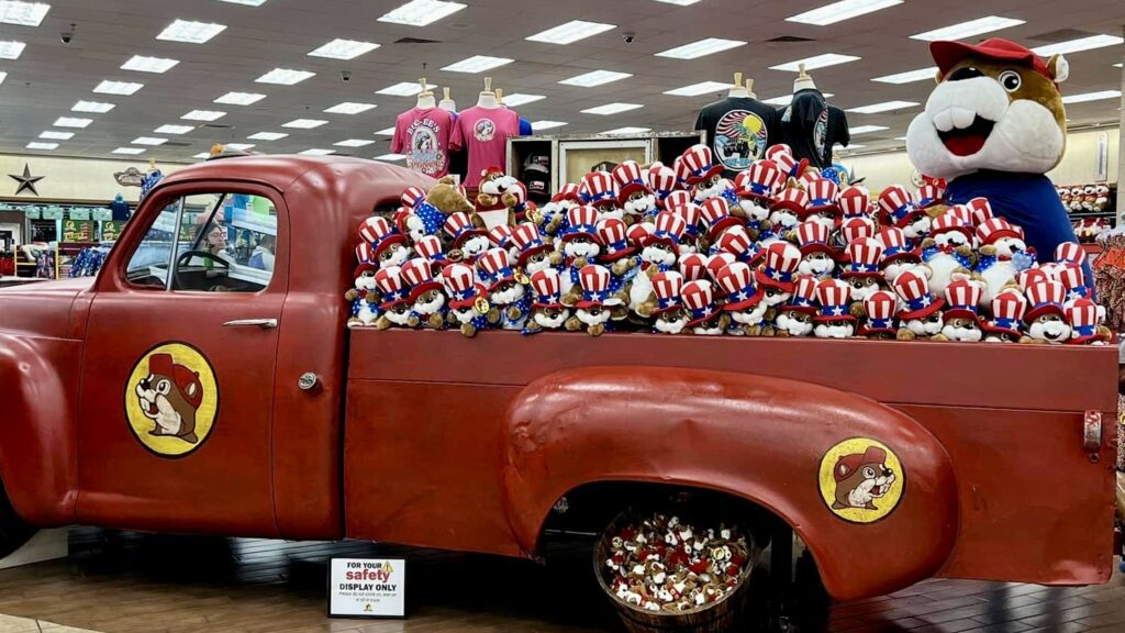 a red truck with stuffed animals on the back