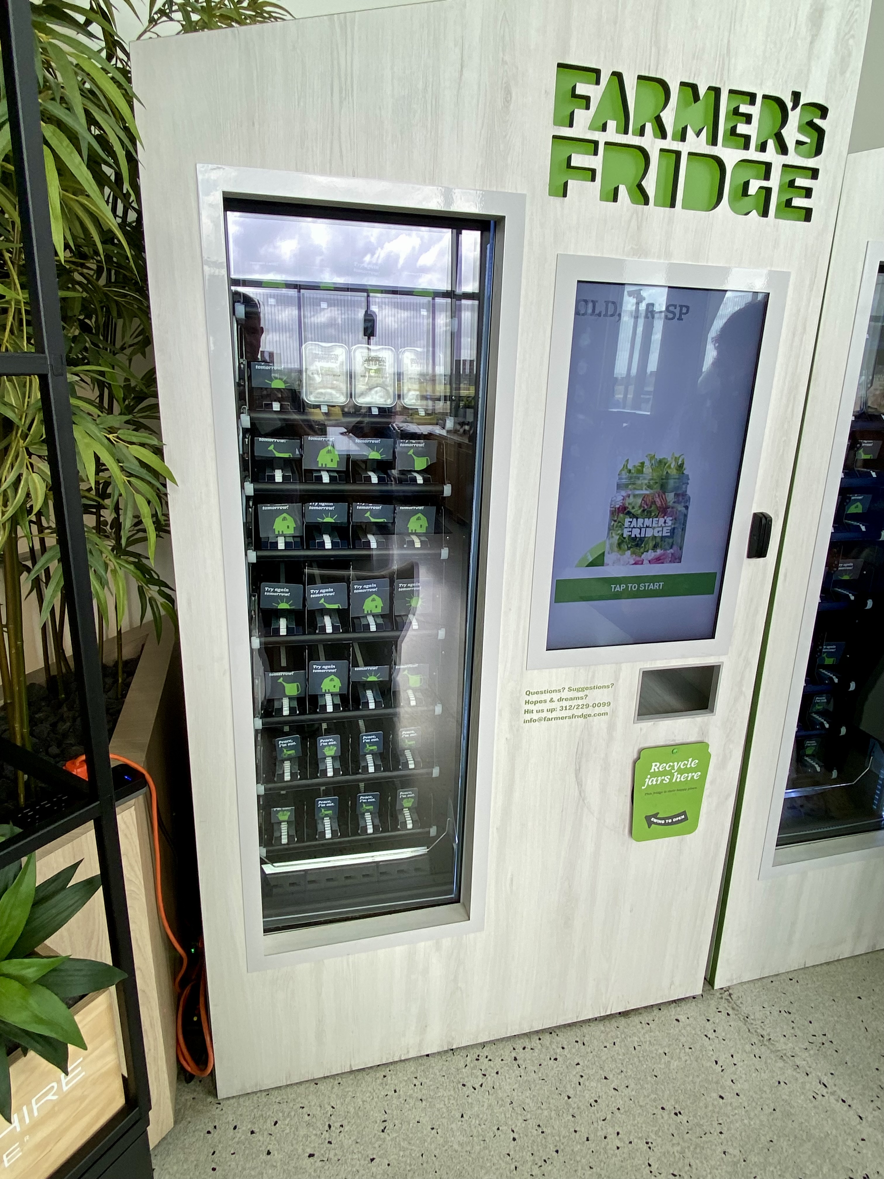 a vending machine with green text