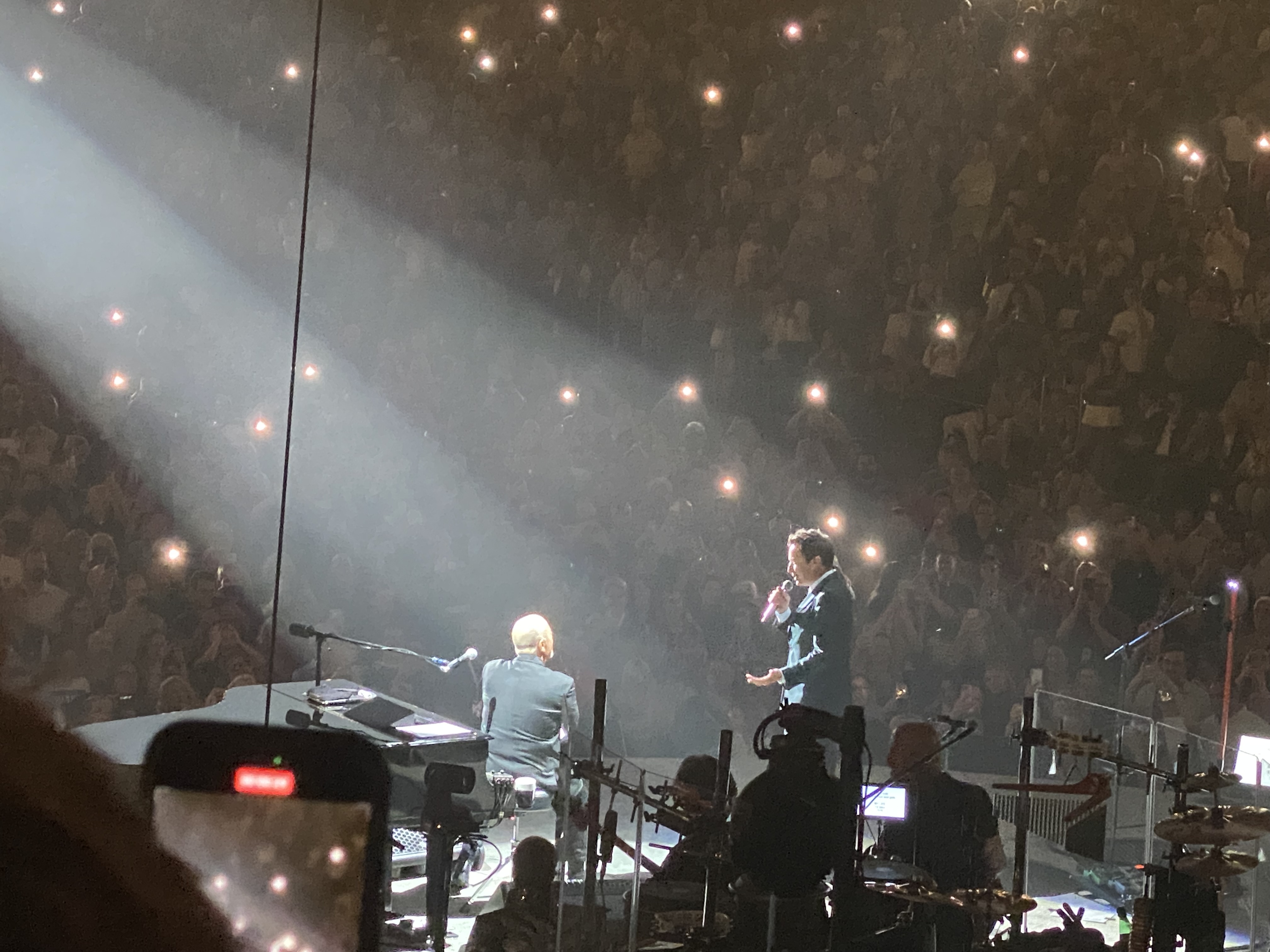 a group of people on a stage with microphones and lights