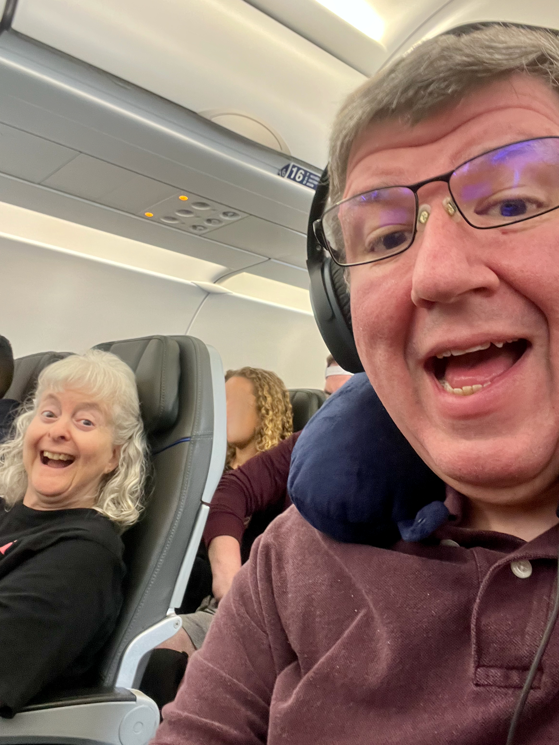 a man and woman sitting in a plane