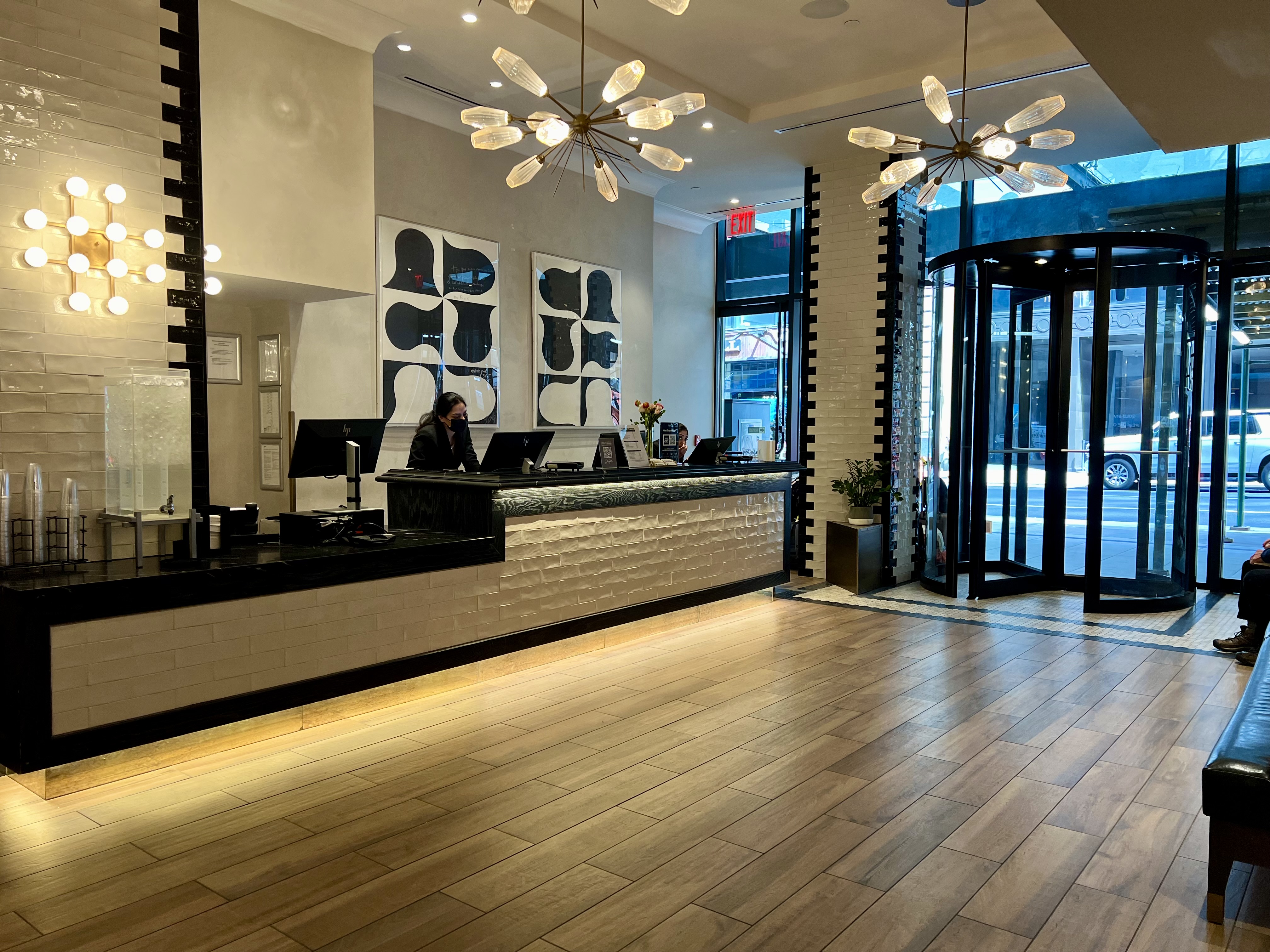 a lobby with a woman at the counter