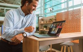 a man sitting at a desk with a laptop