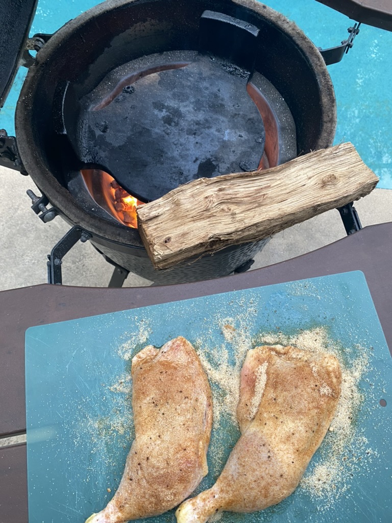 food on a cutting board next to a fire