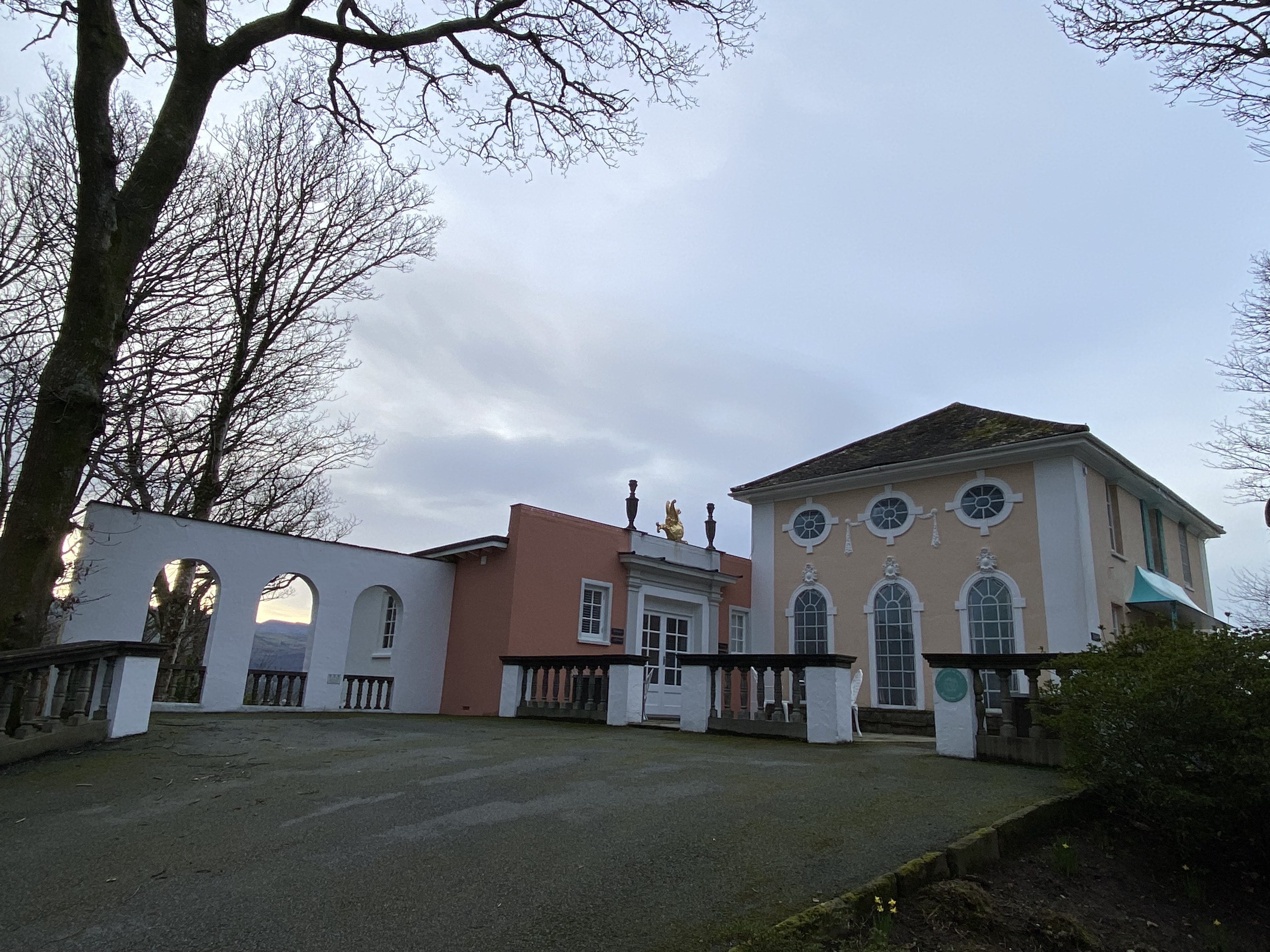 a building with a fence and a driveway