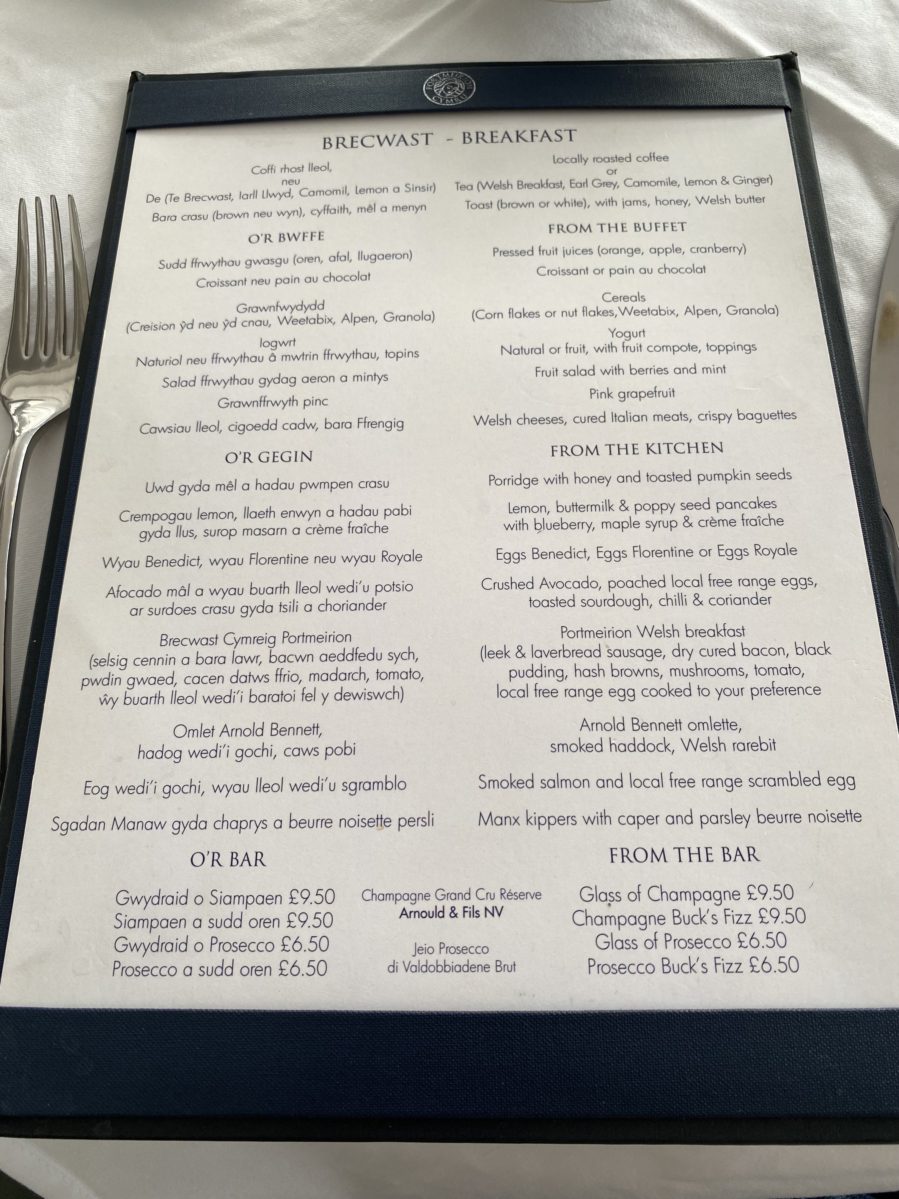 a menu with a fork on a table