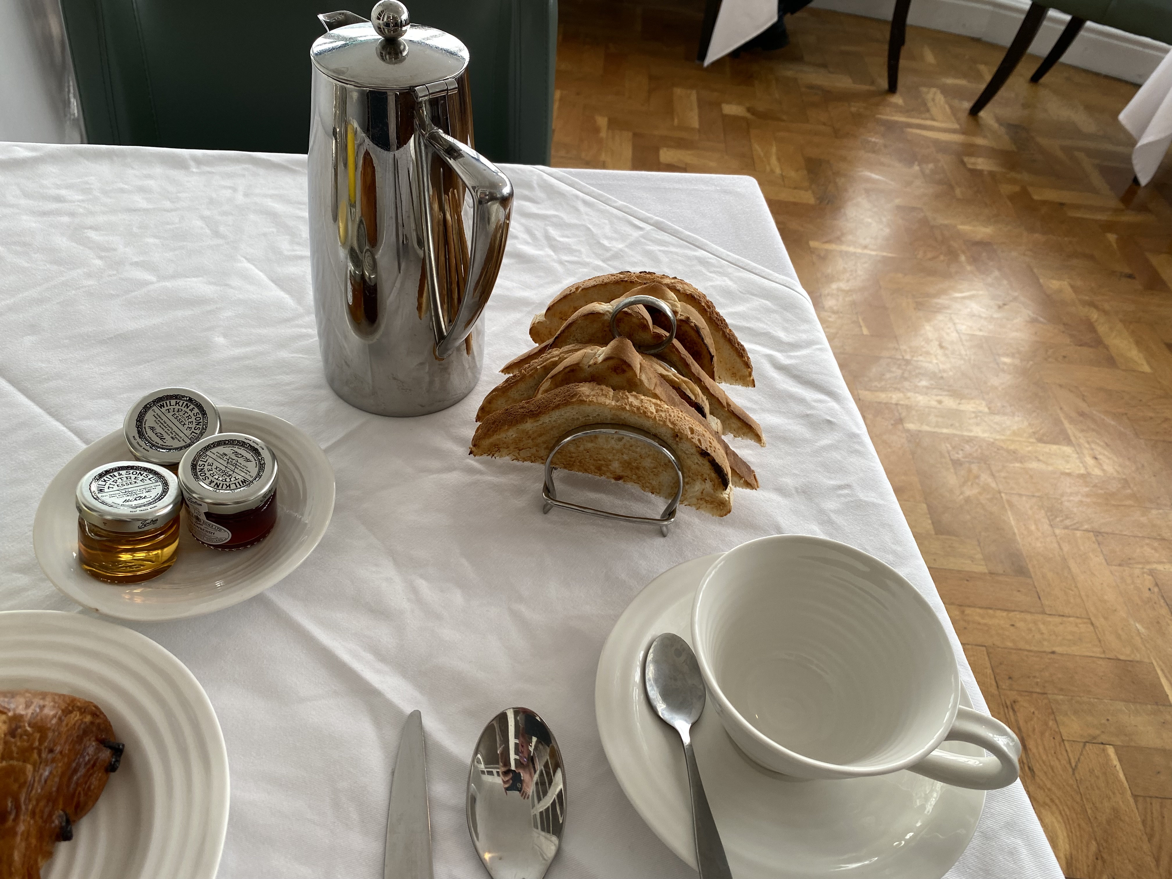 a plate of food and a coffee pot on a table