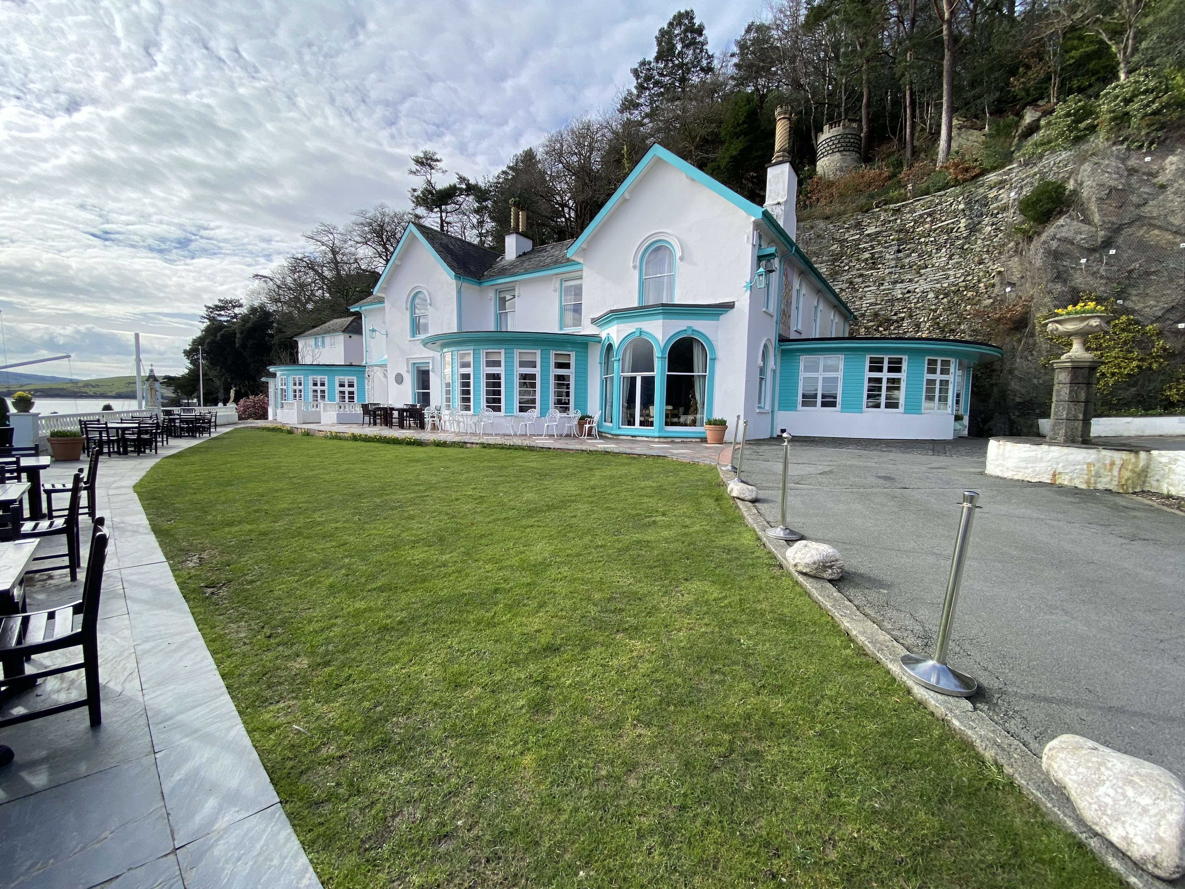 a house with a lawn and a stone wall