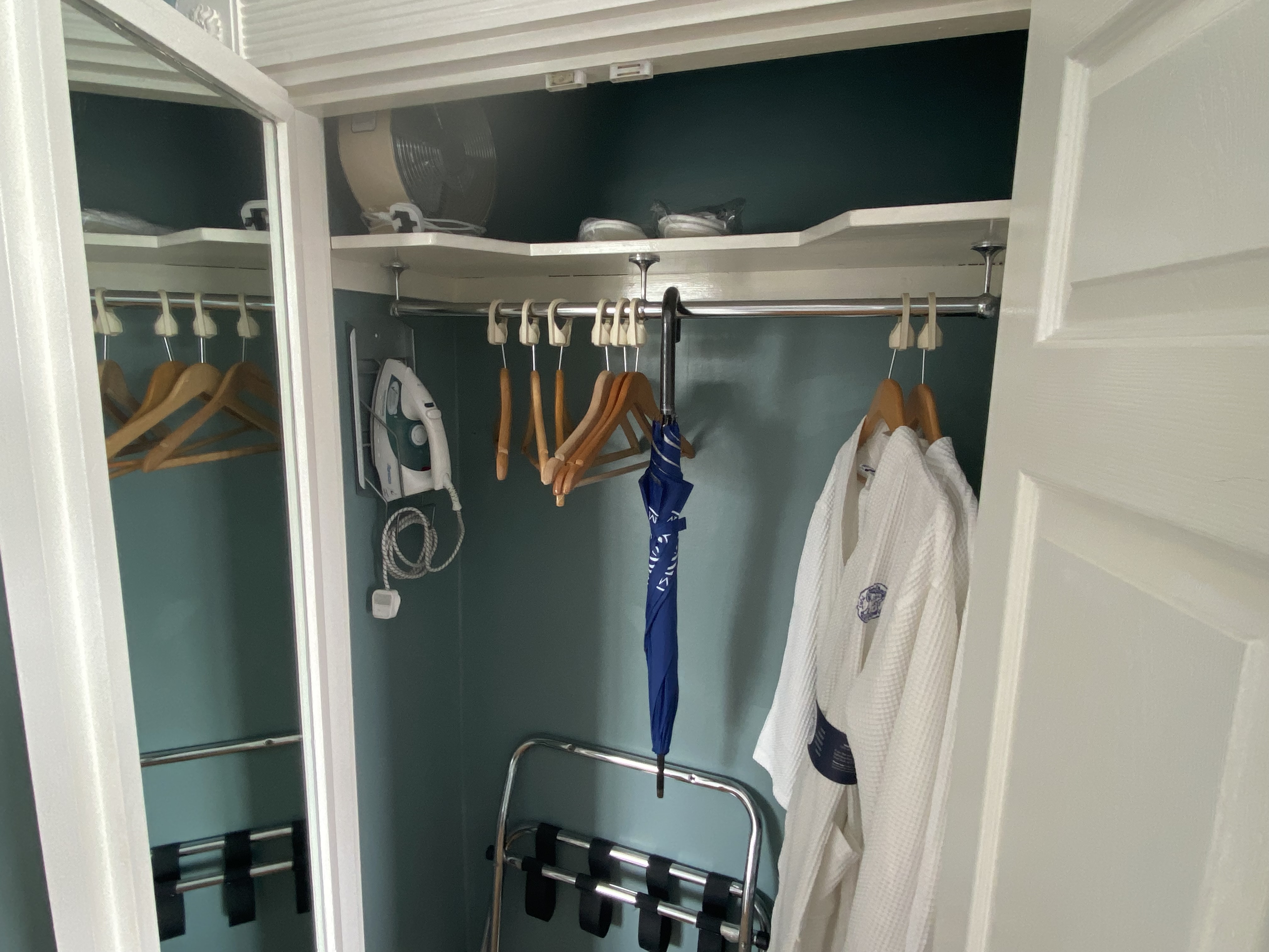 a closet with clothes on hooks