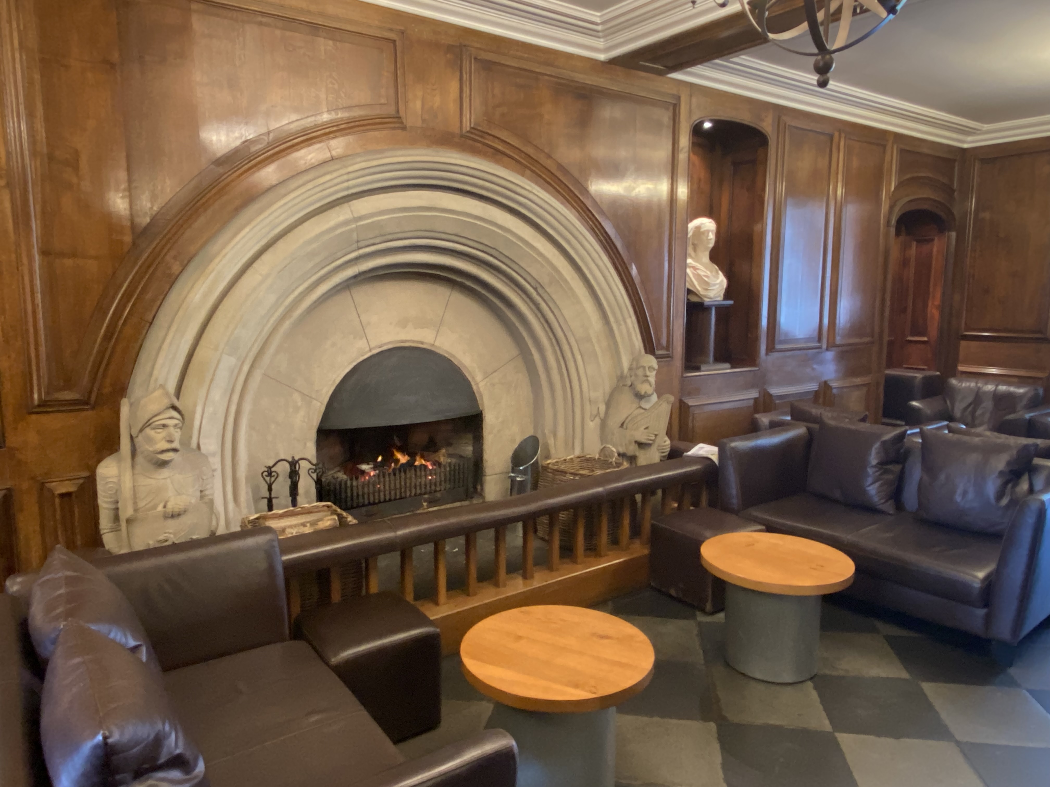 a room with a fireplace and a chandelier