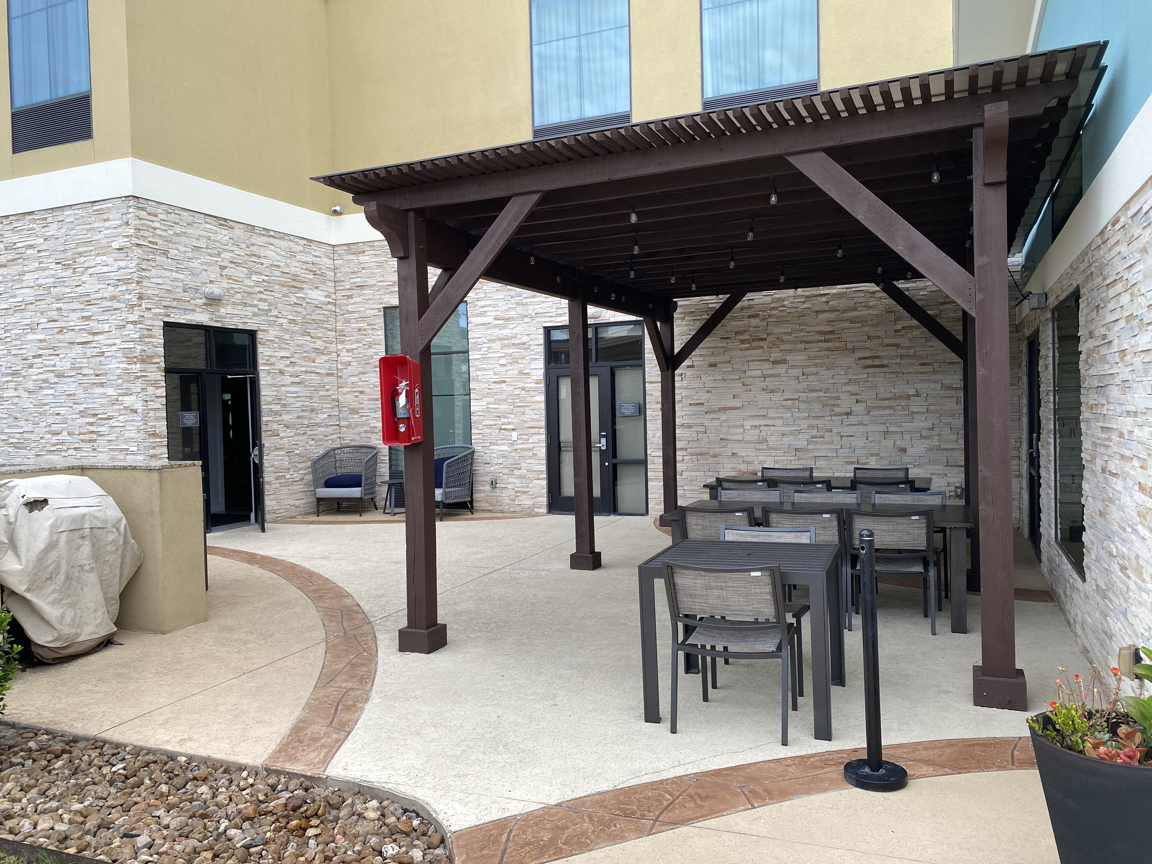 a patio with a table and chairs