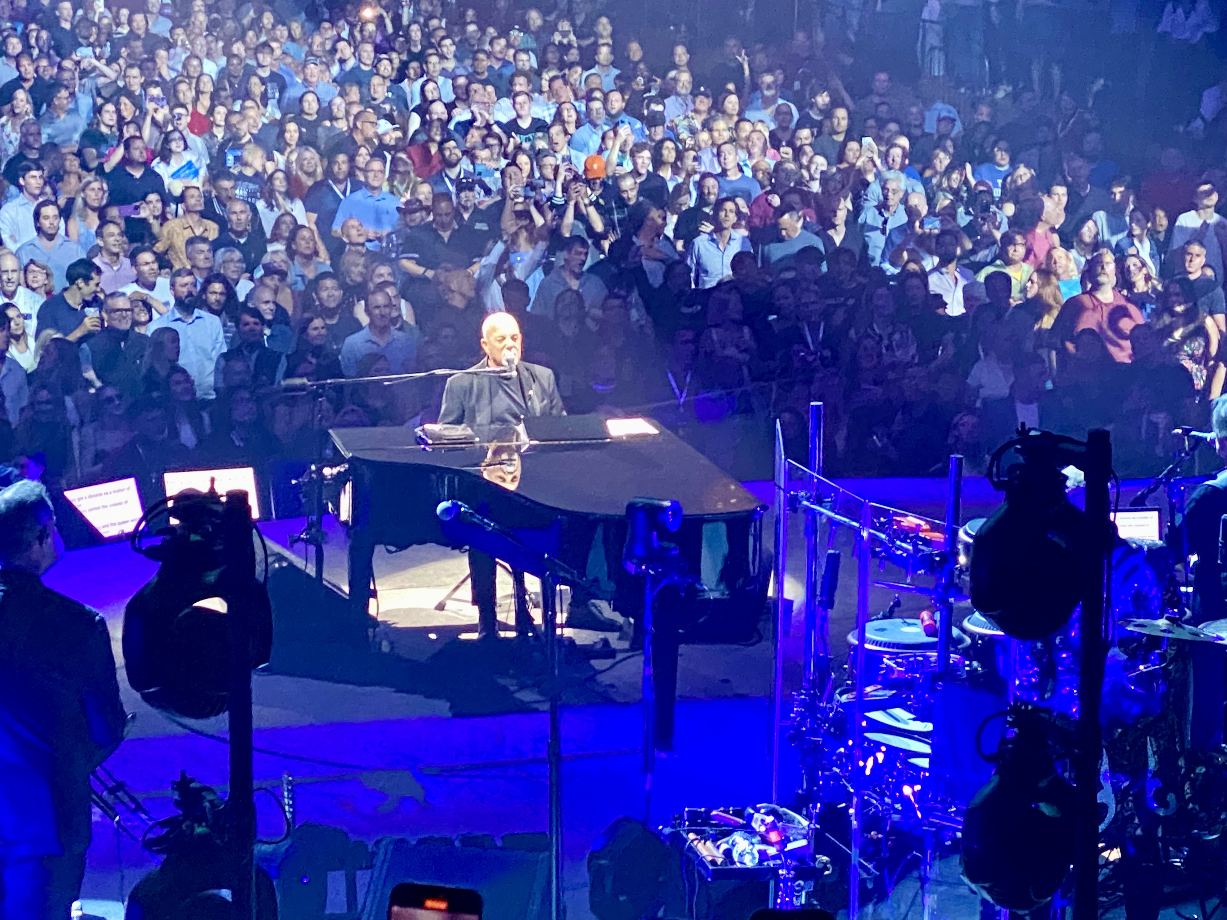 a man on a stage with a large crowd watching