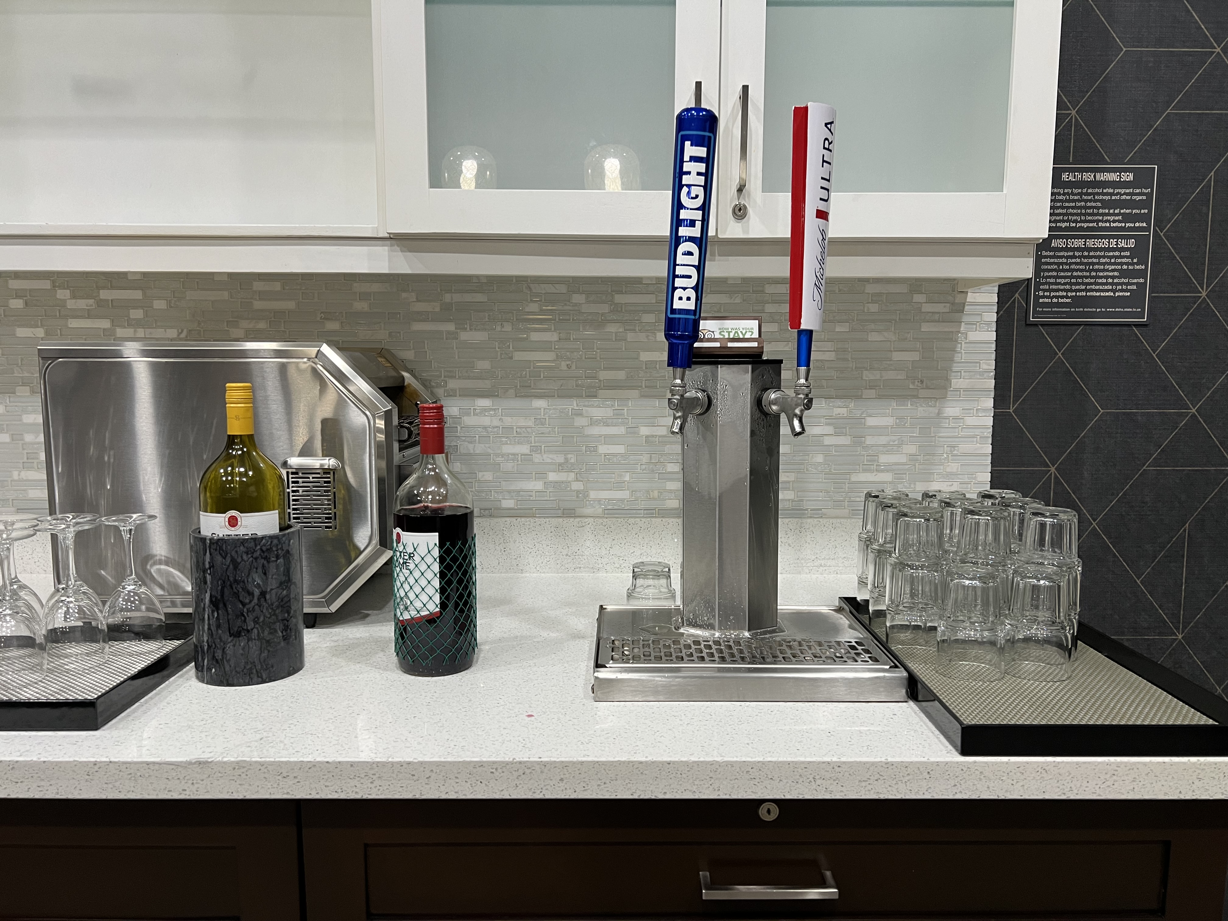 a bar counter with a tap and glasses