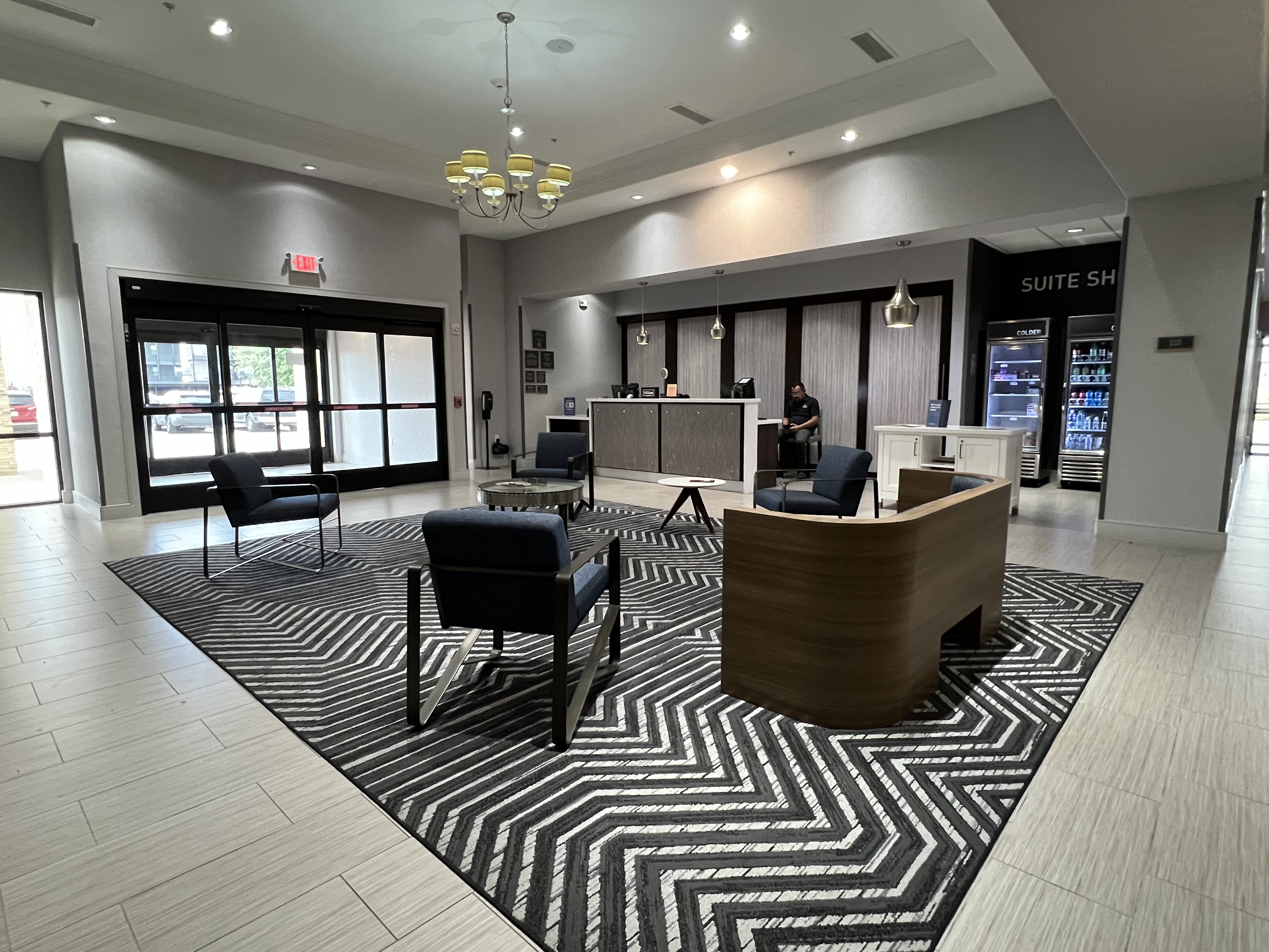 a lobby with chairs and a desk