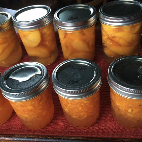 a group of jars of fruit jam