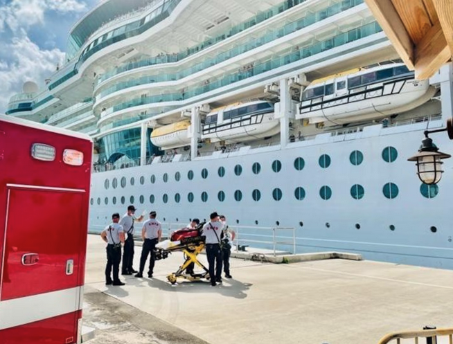 a group of people standing next to a large cruise ship