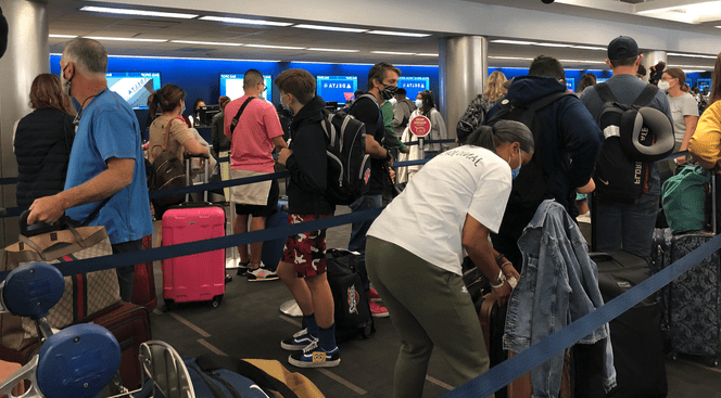 a group of people in a line at an airport