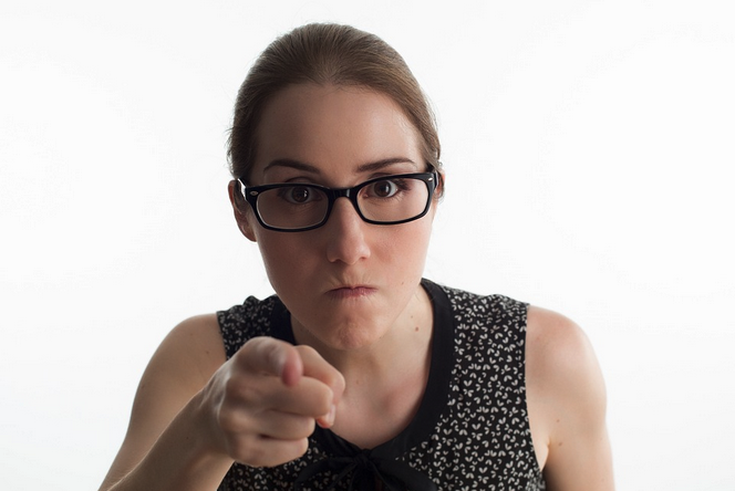 a woman pointing at camera