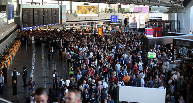 a large crowd of people in an airport