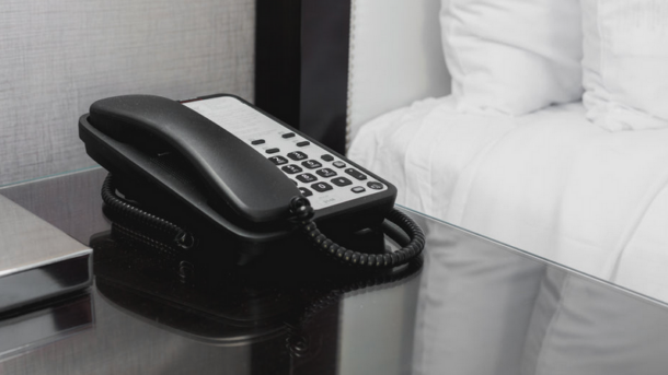 a black telephone on a glass table