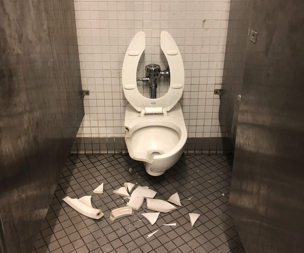 a broken toilet in a bathroom