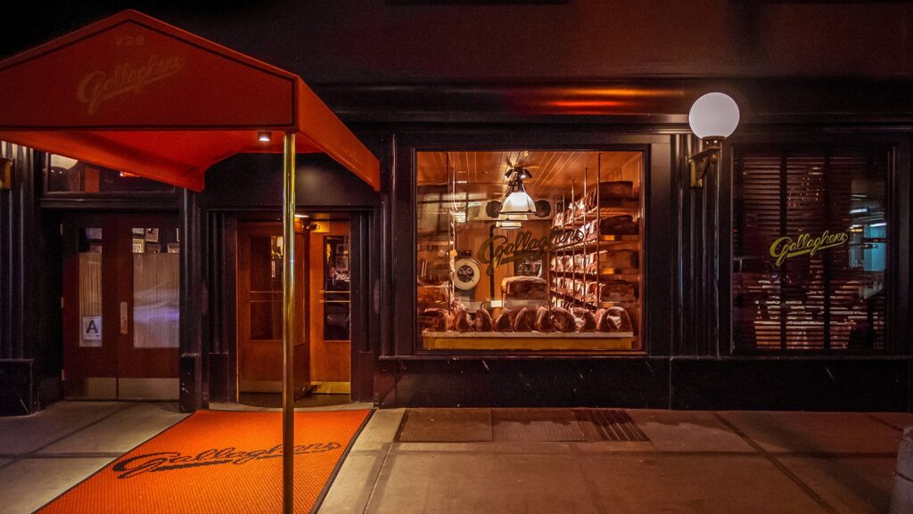 a store front with a door and a red awning