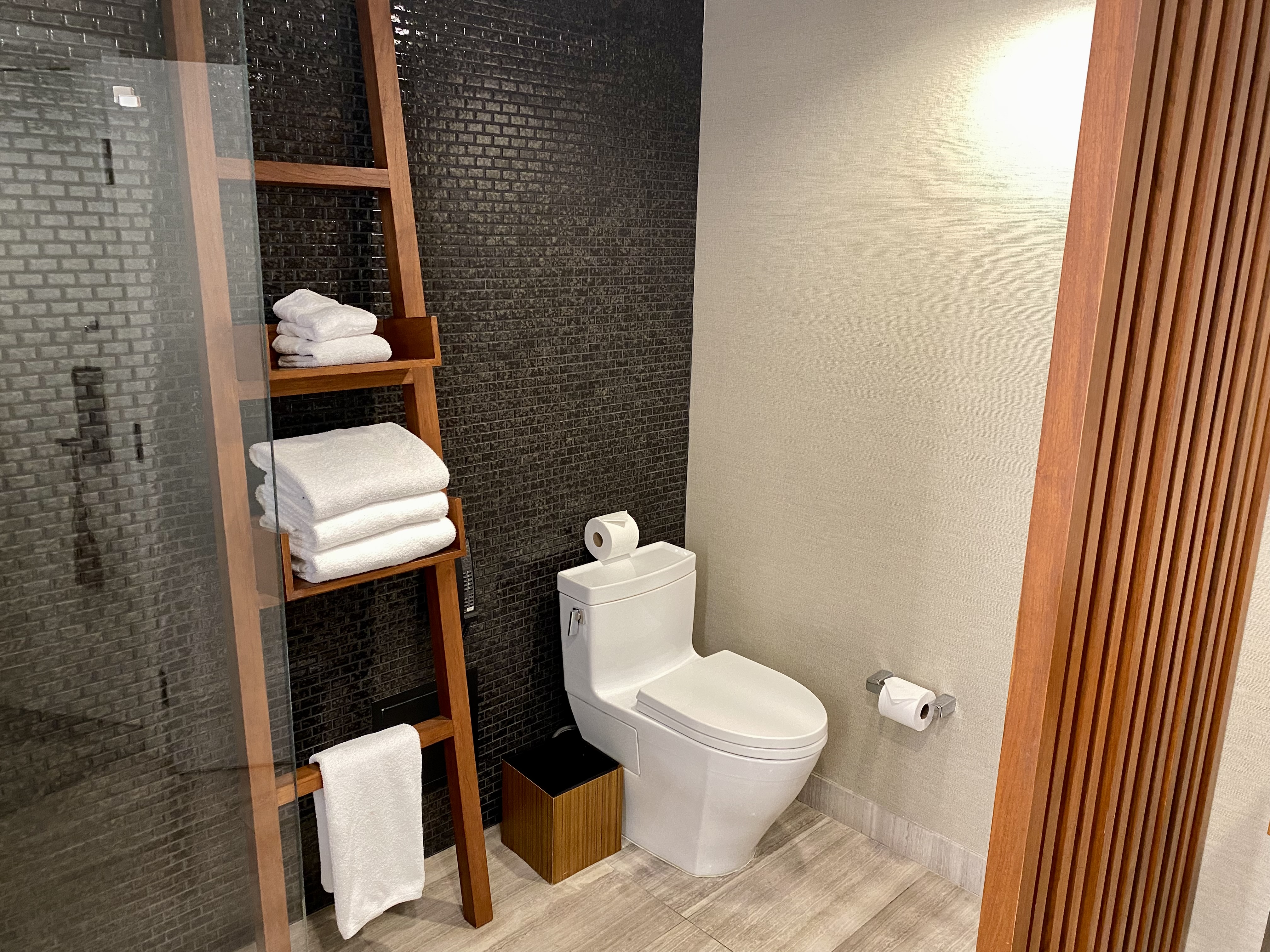 a bathroom with a shelf and toilet