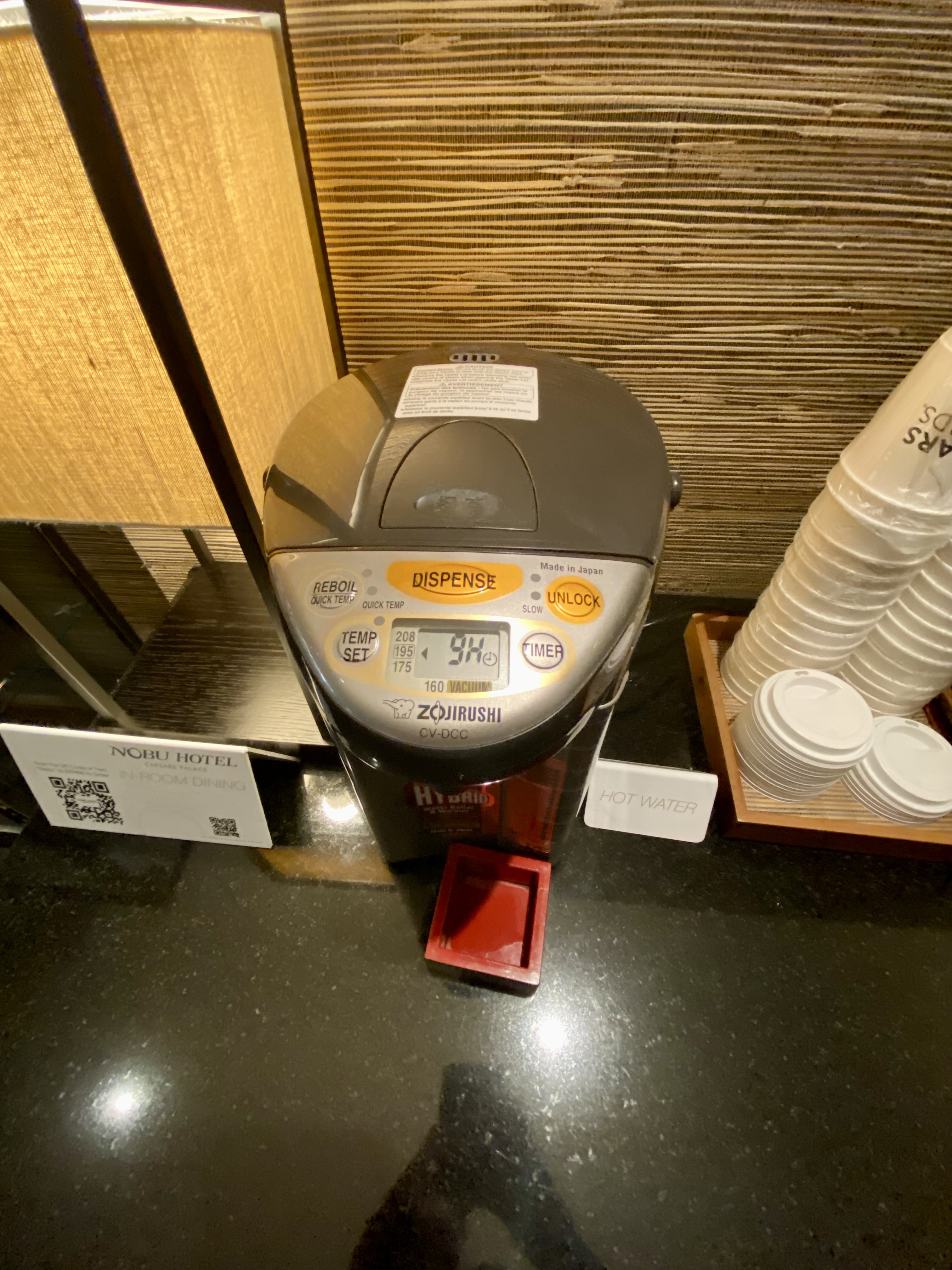 a coffee machine and cups on a counter