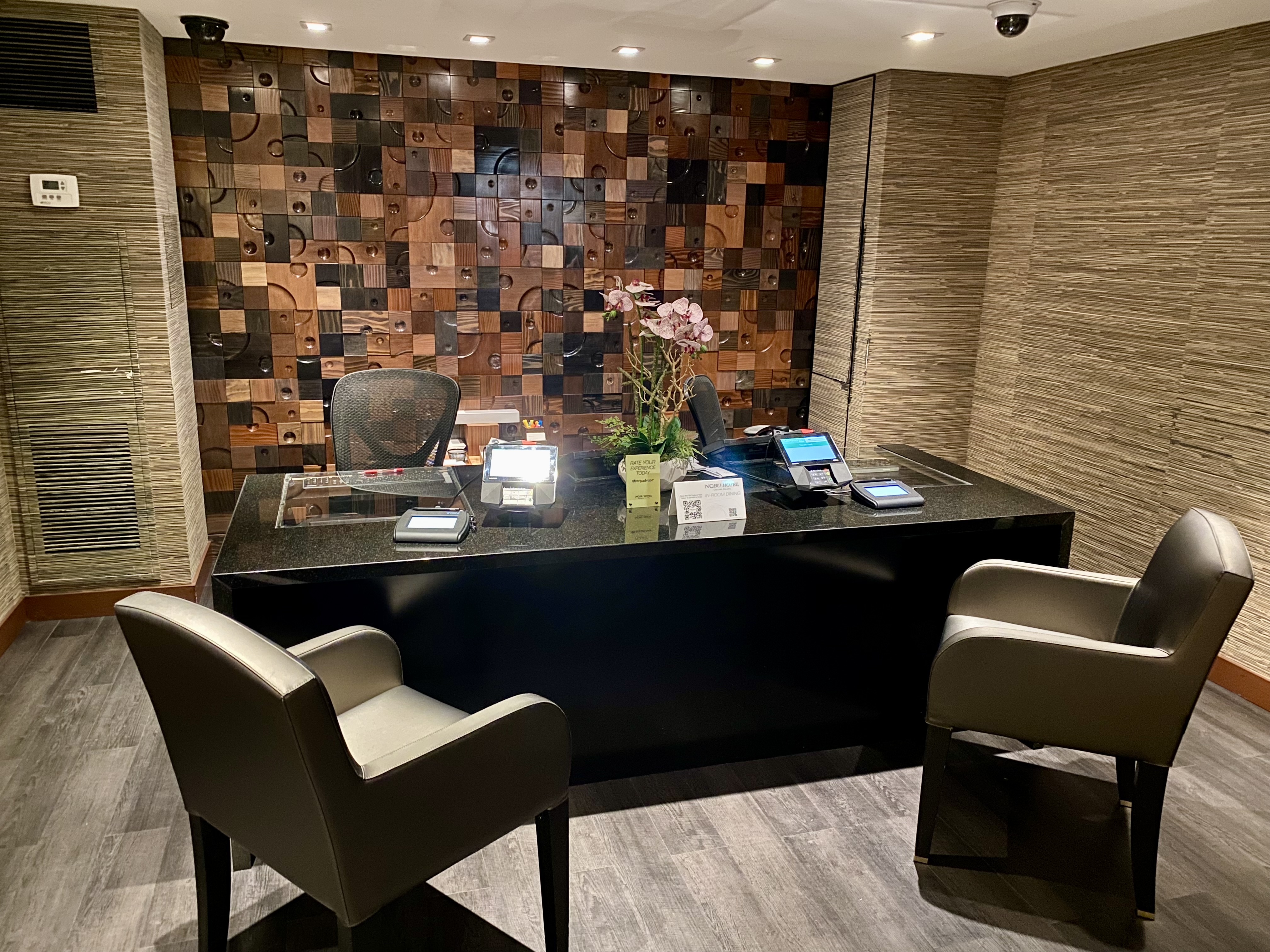 a room with a black table and chairs