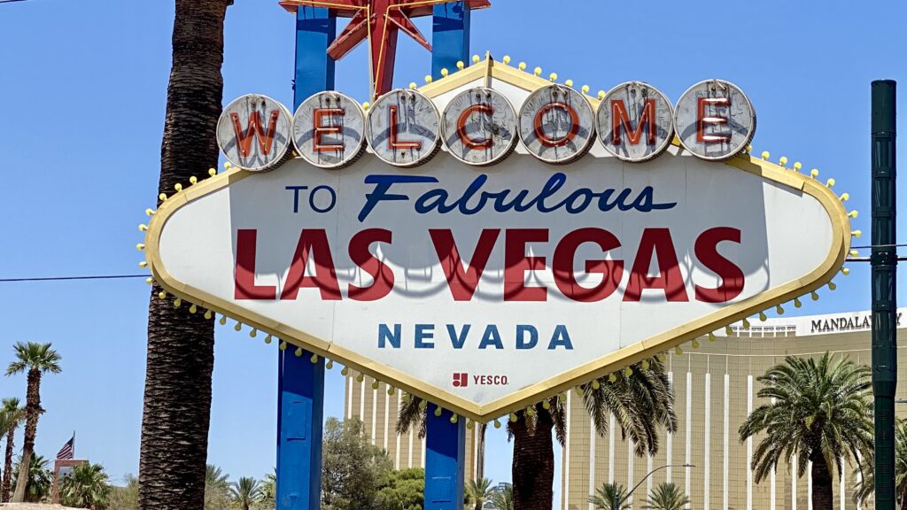 a sign with a star and text with Welcome to Fabulous Las Vegas sign in the background