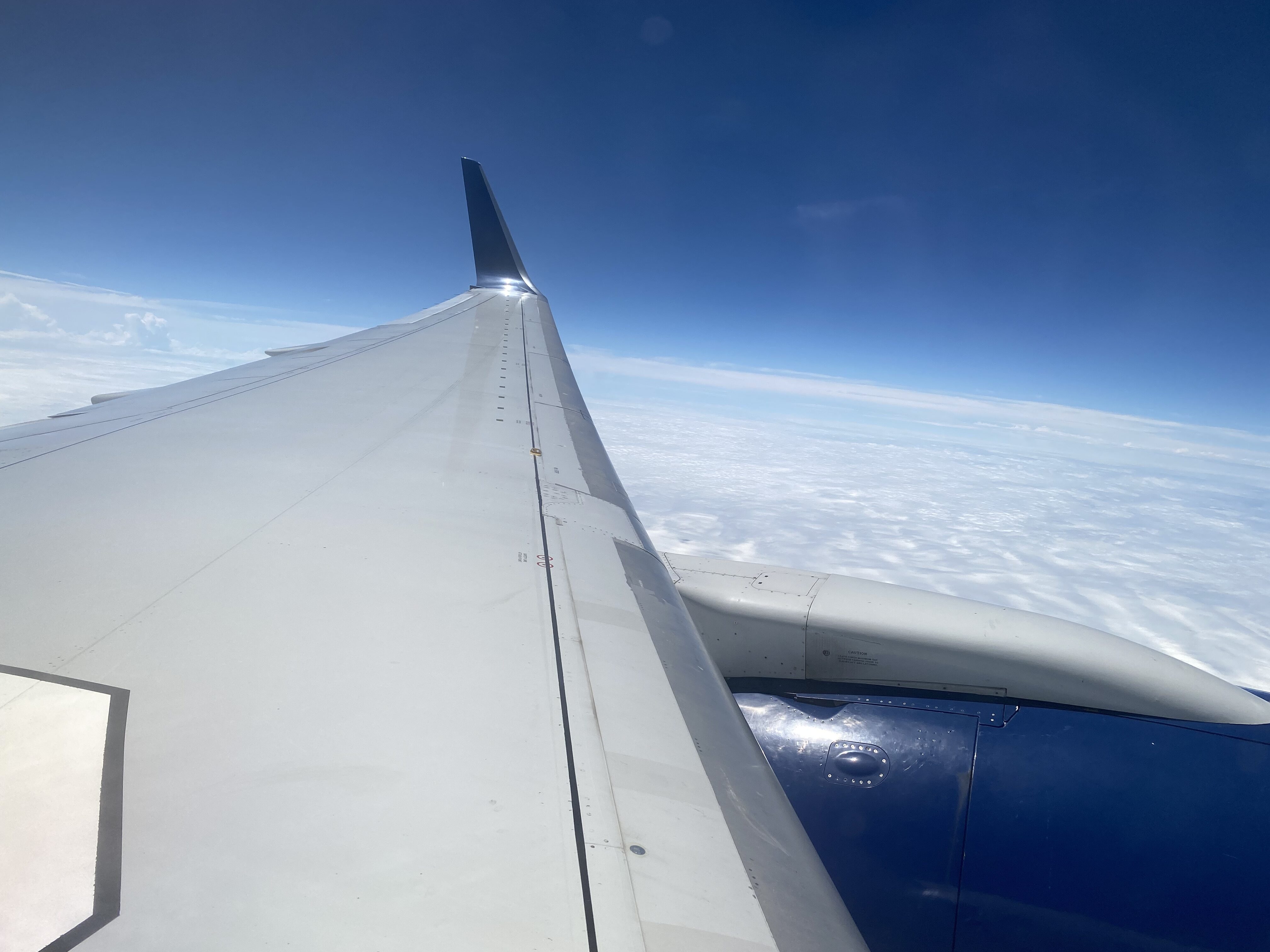 the wing of an airplane above the clouds