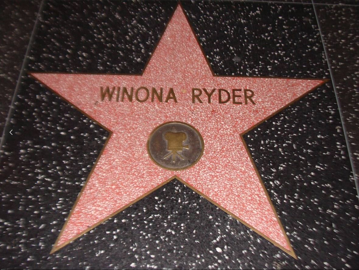 a star on the ground with Hollywood Walk of Fame in the background