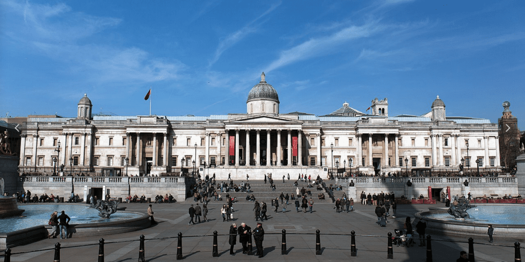 a large white building with columns and a dome with The National Gallery in the background