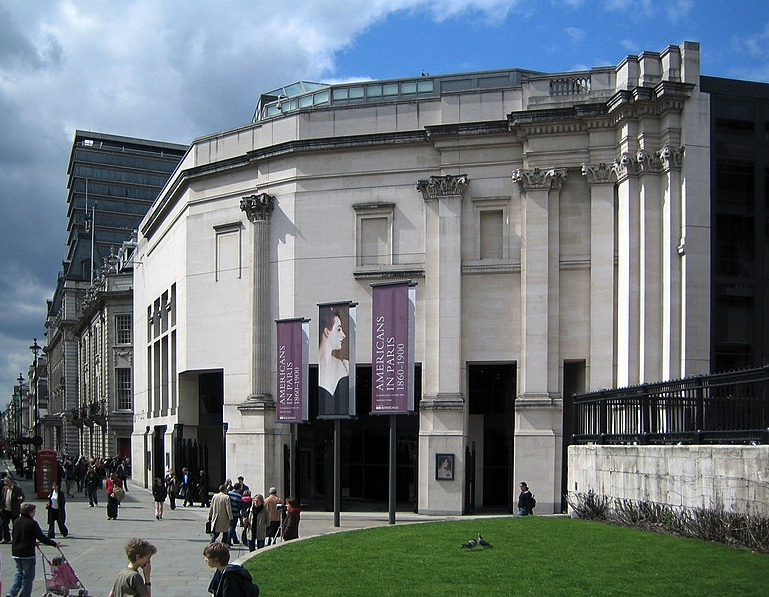 a group of people walking in front of a building