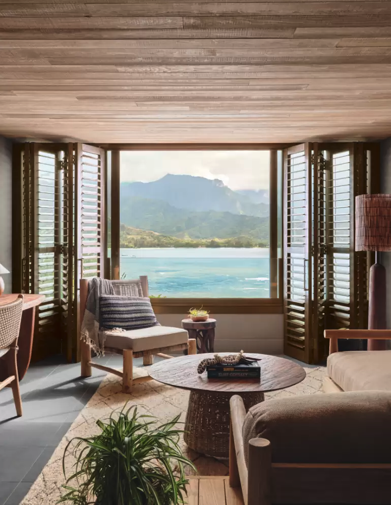 a room with a view of the ocean and mountains