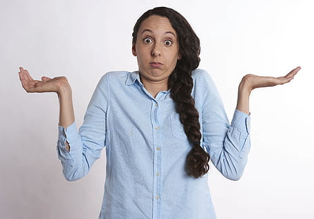 a woman with long hair making a face with her hands