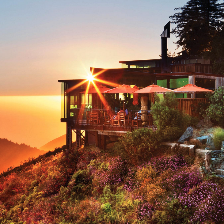 a building with a view of the ocean and the sun