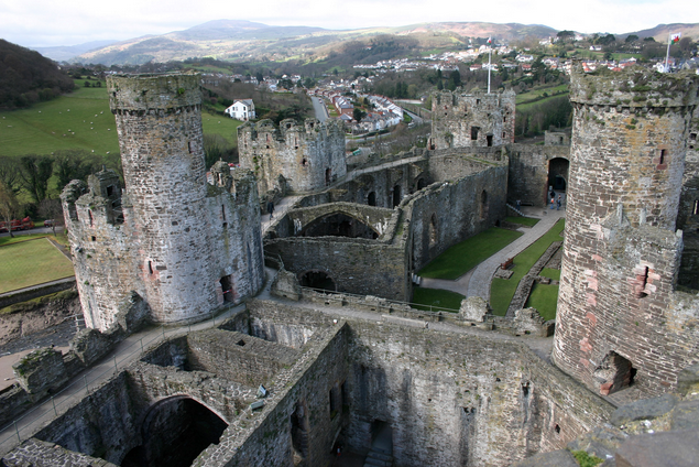 a castle with towers and a city in the background