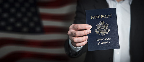 a hand holding a passport