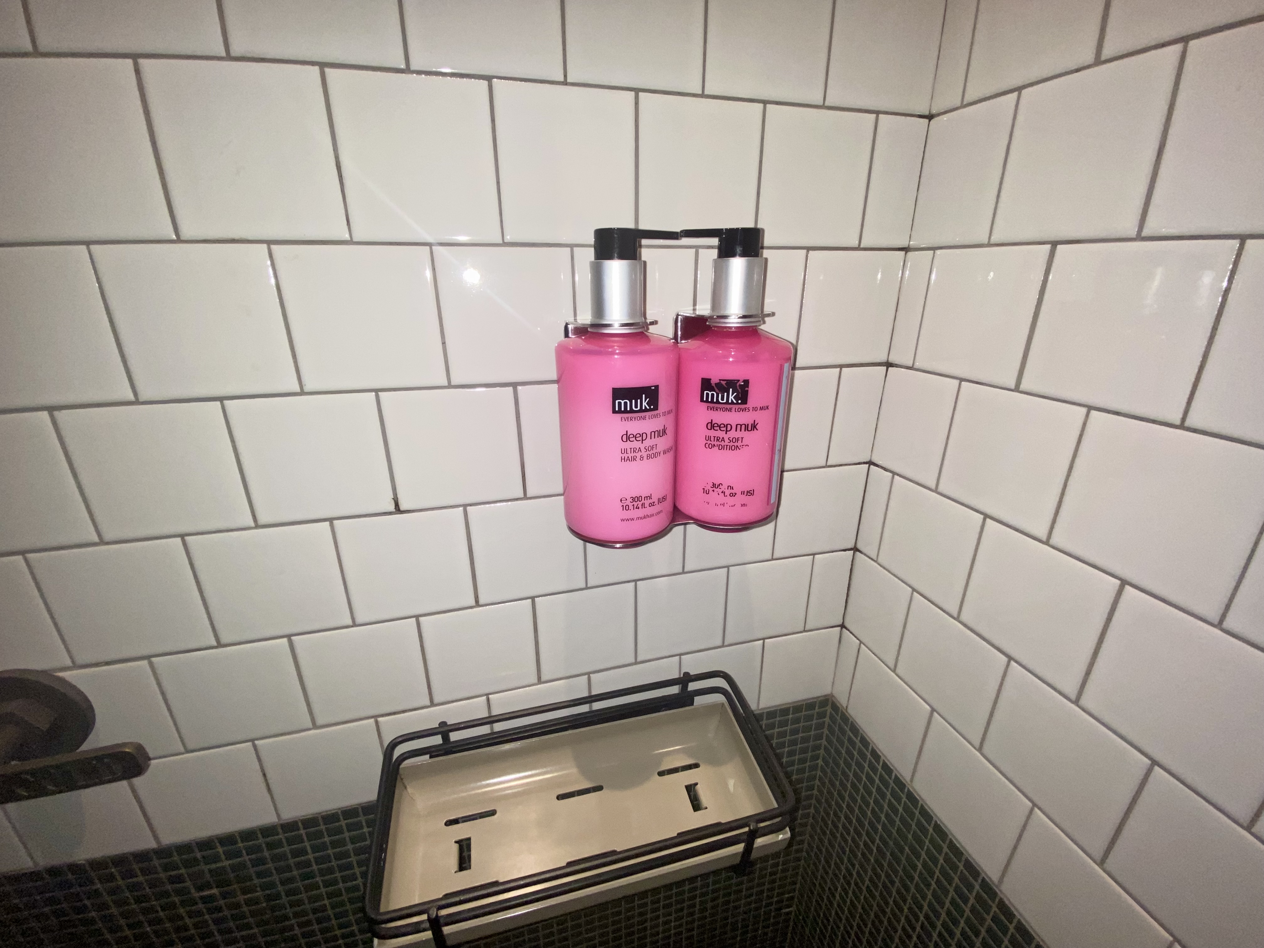 a pink bottles of liquid on a wall