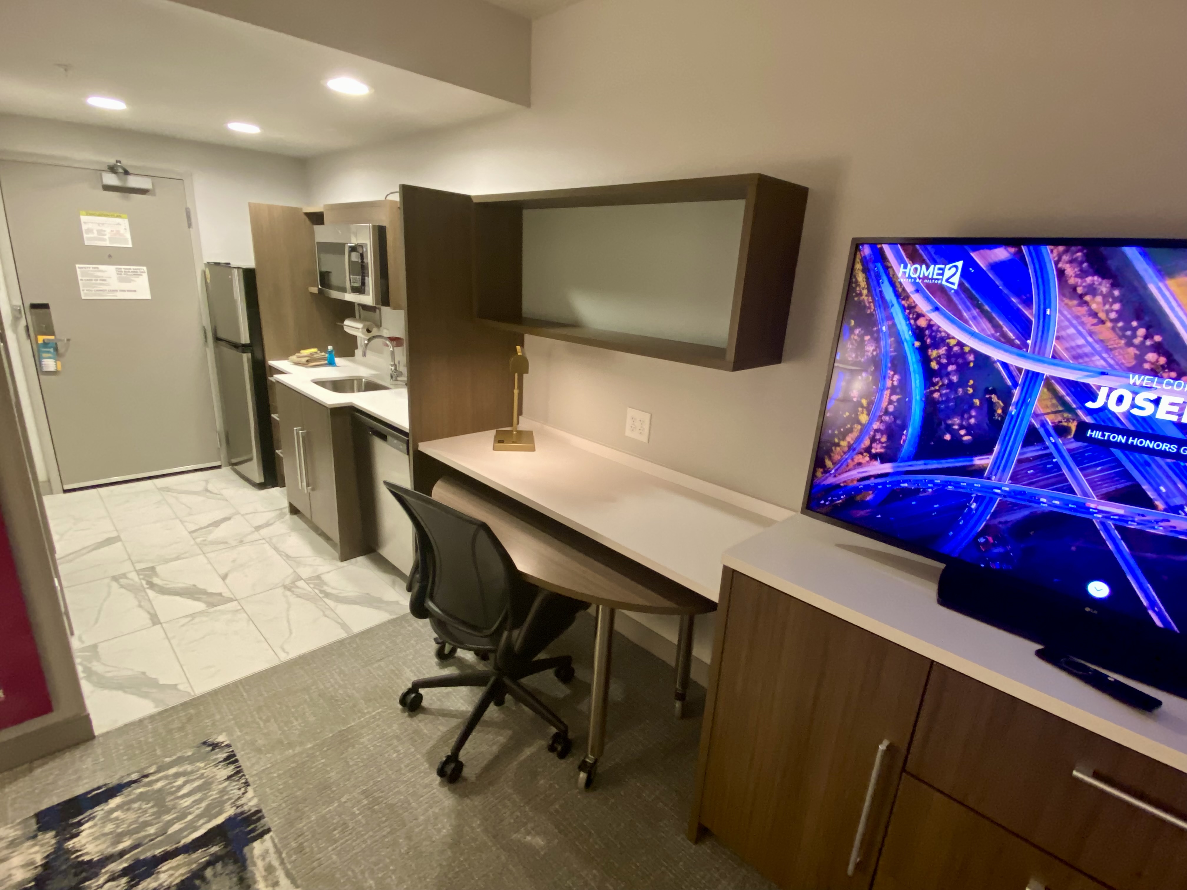 a room with a television and a desk