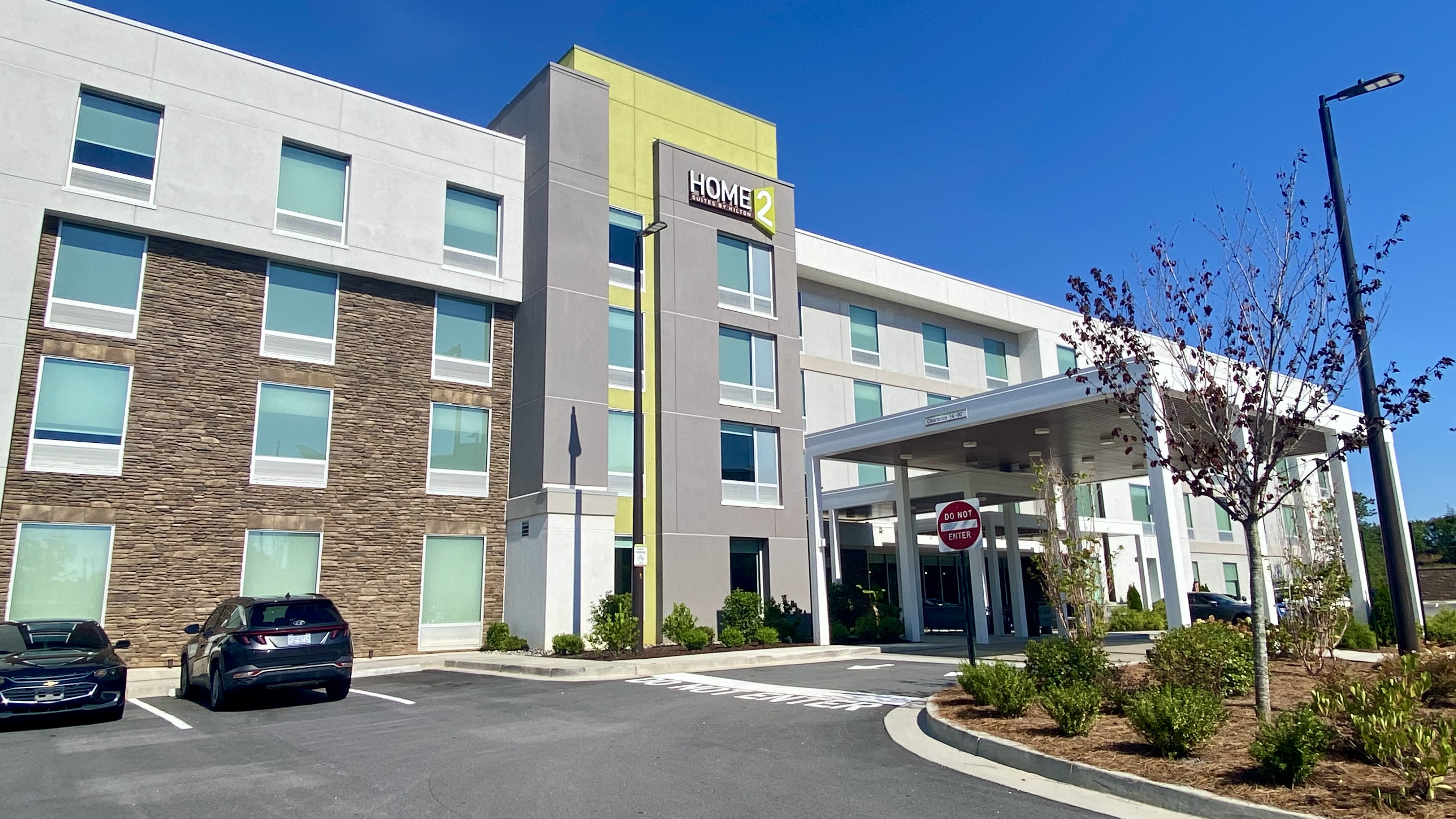 a building with a parking lot and a parking lot