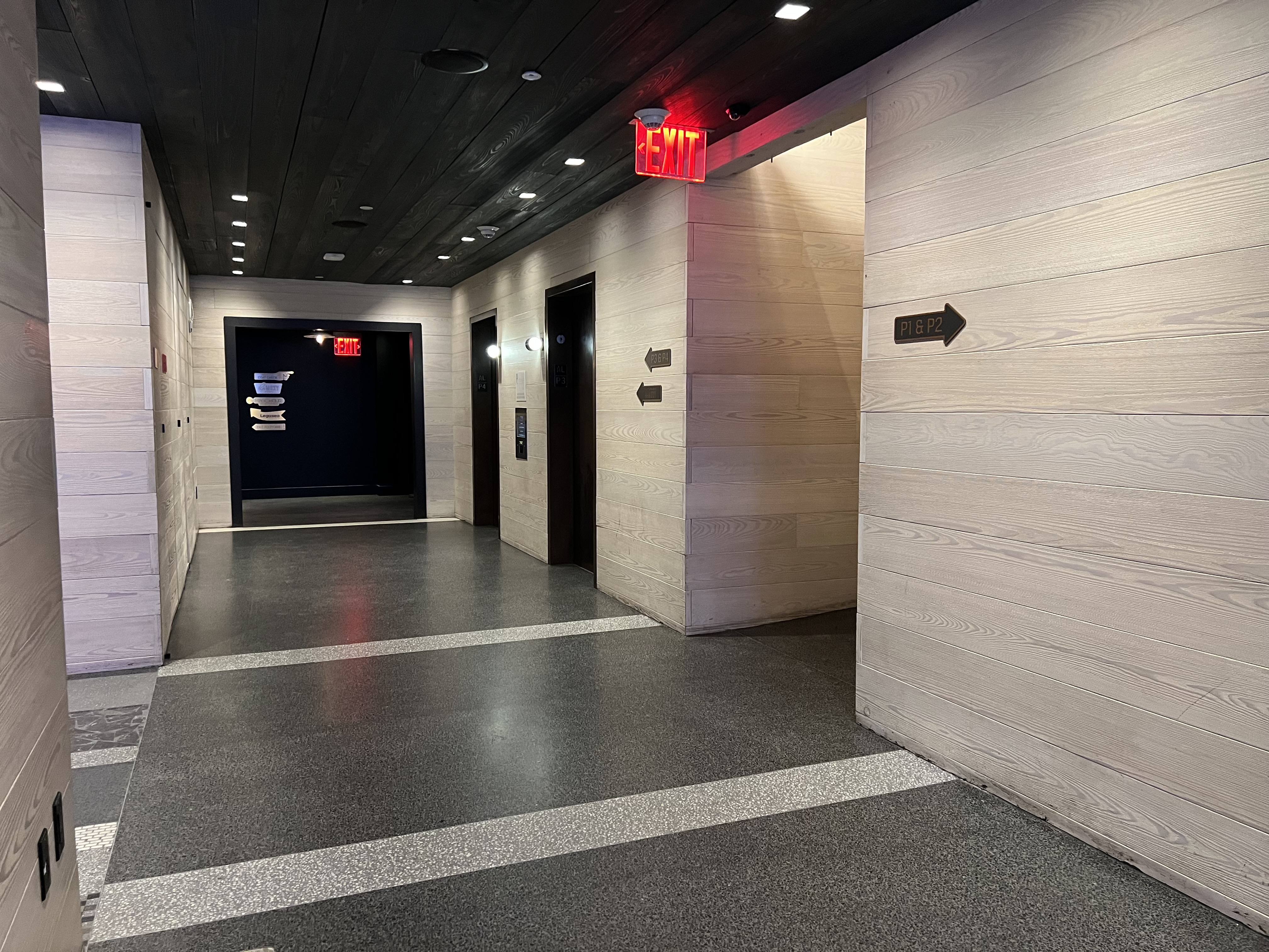 a hallway with doors and signs