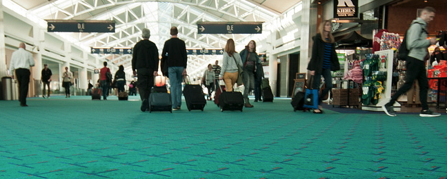 a group of people with luggage in an airport