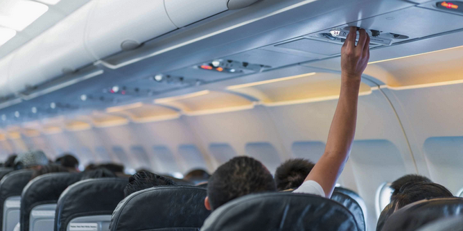 a person holding an object above the ceiling