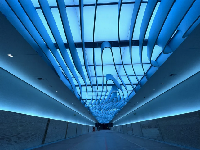 a long corridor with a blue ceiling