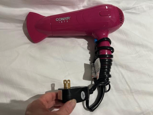 a hand holding a hair dryer