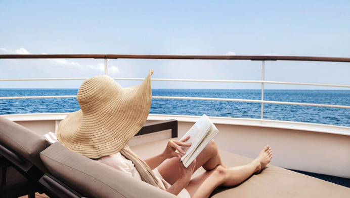 a woman reading a book on a boat